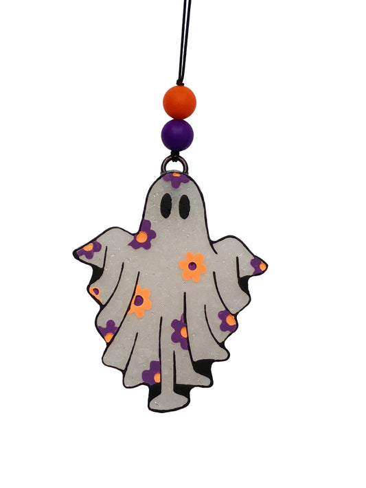 This adorable ghost-shaped freshie features a crisp white base with black outline details, accented with vibrant orange and purple flowers and matching beads for that perfect Halloween vibe.