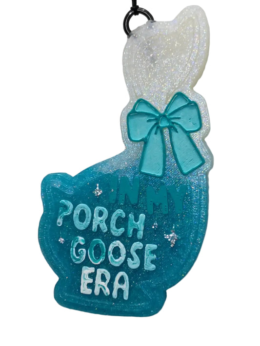 Hanging Car air freshenerwith 'Porch Goose Era' text in blue and white on a white and blue ombre background.